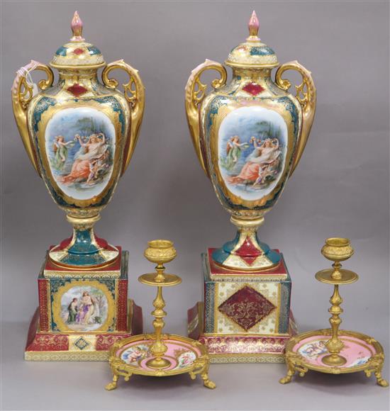 A pair of Austrian style lidded urns and a pair of gilt and ceramic candlesticks urns height 41cm